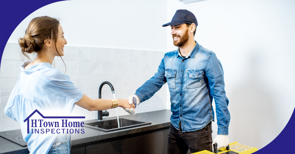 Home inspector greeting client in modern kitchen setting.