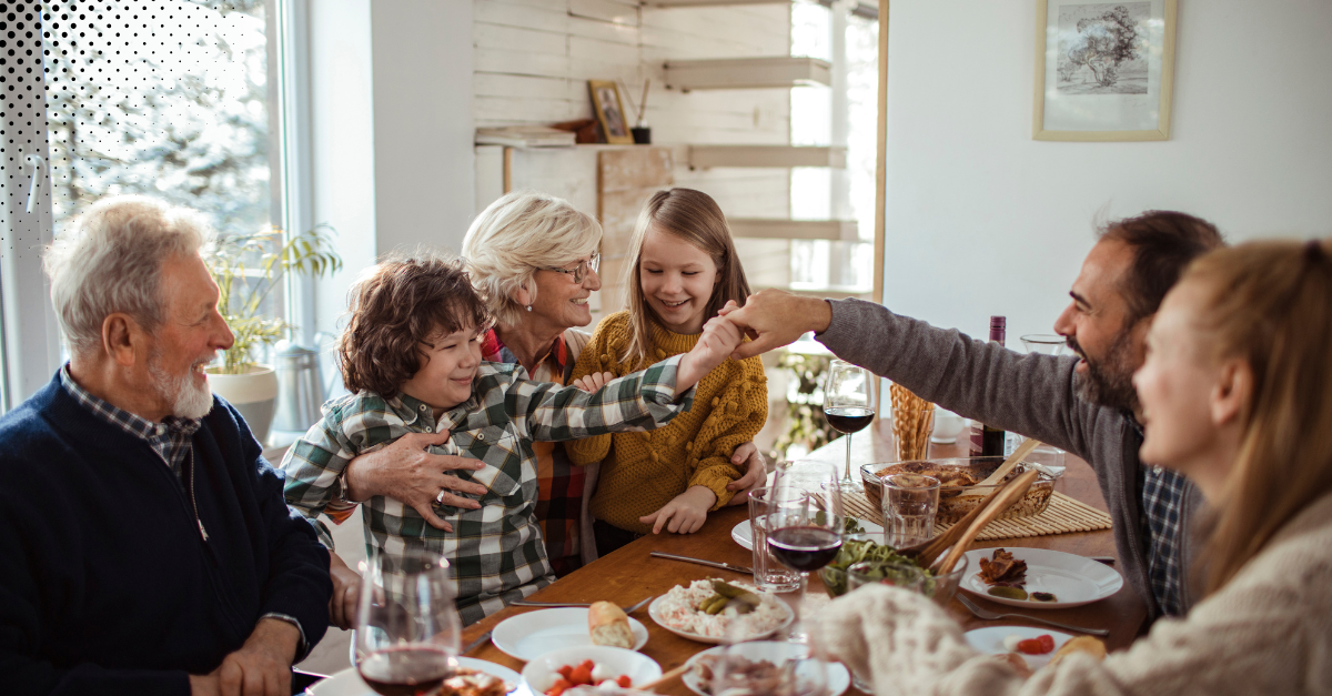 Family gathered around a table sharing a meal at home.