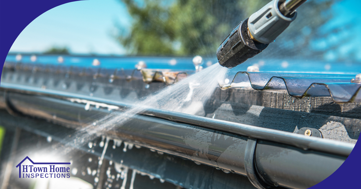 Water jet cleaning a house gutter.