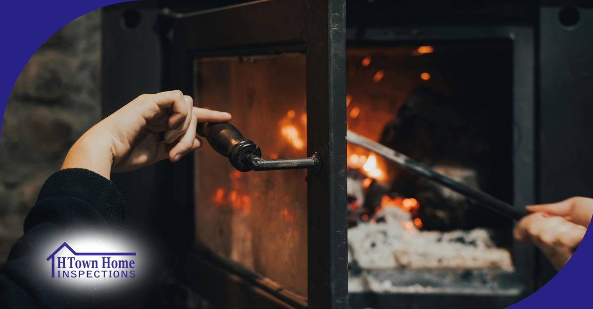 Hands opening and tending to a wood-burning stove with fire inside.