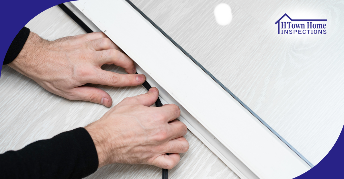 Hands installing weatherstripping on a sliding door.
