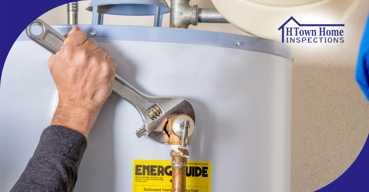 Hand tightening a water heater connection with a wrench.