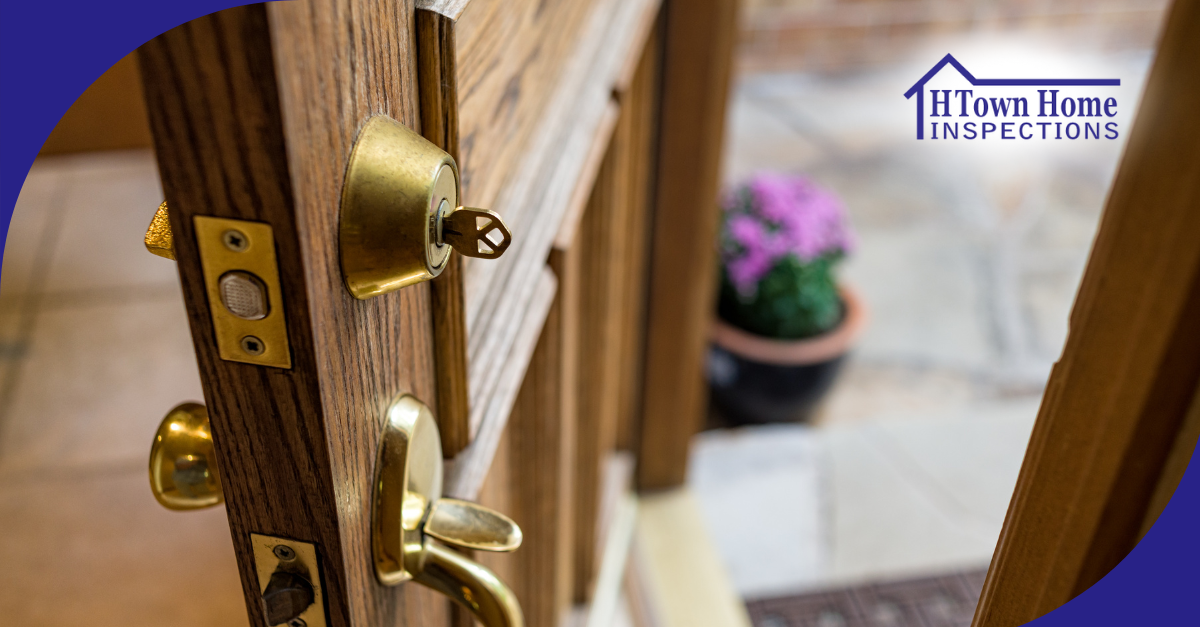 Key inserted in a front door lock with the door slightly open.
