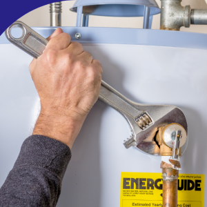 Hand tightening a water heater connection with a wrench.