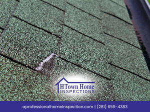 Green roof shingles with noticeable damage from weathering.