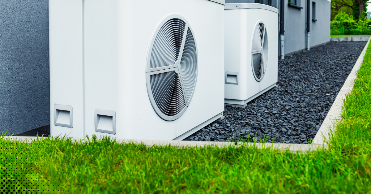 Outdoor air conditioning units installed beside a modern home.